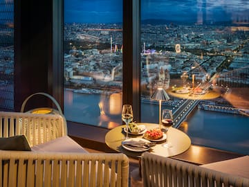 a table with food and wine glasses in front of a window