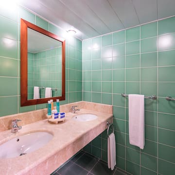 a bathroom with green tiles