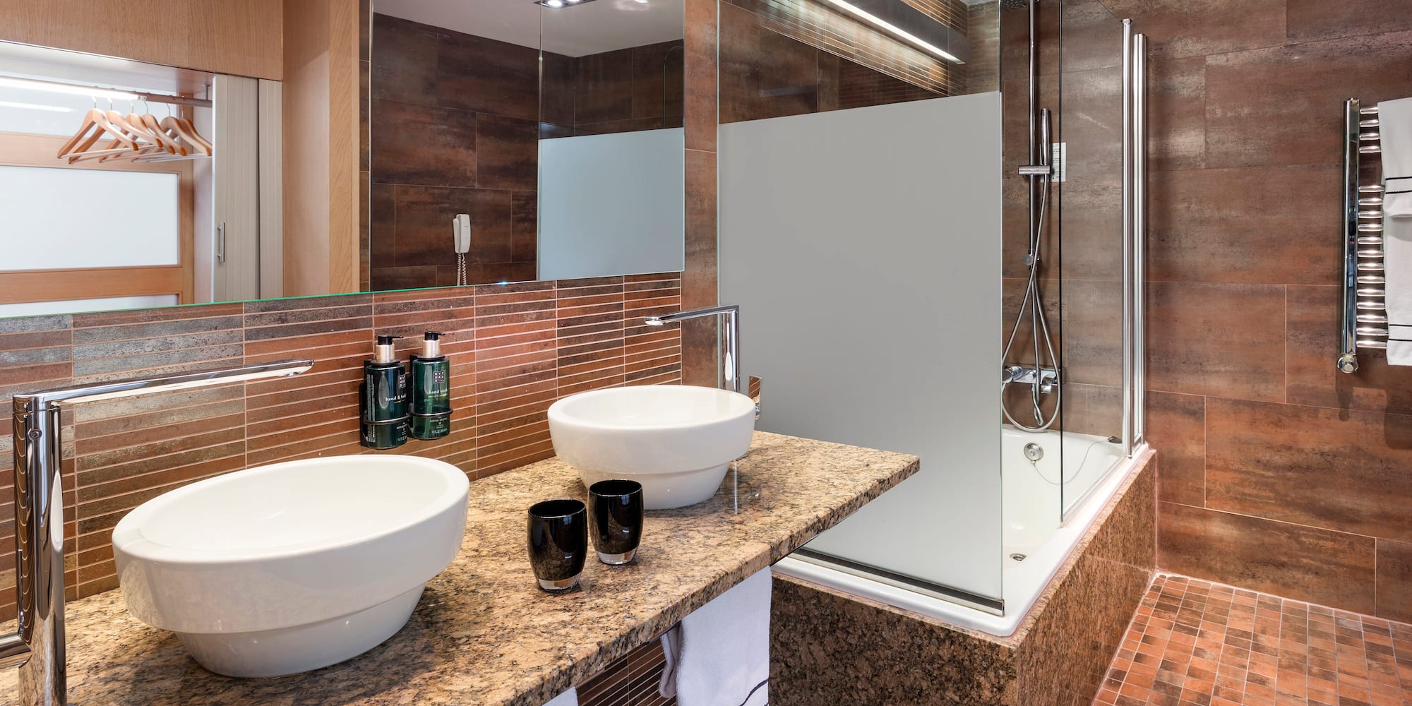 a bathroom with a shower and two sinks