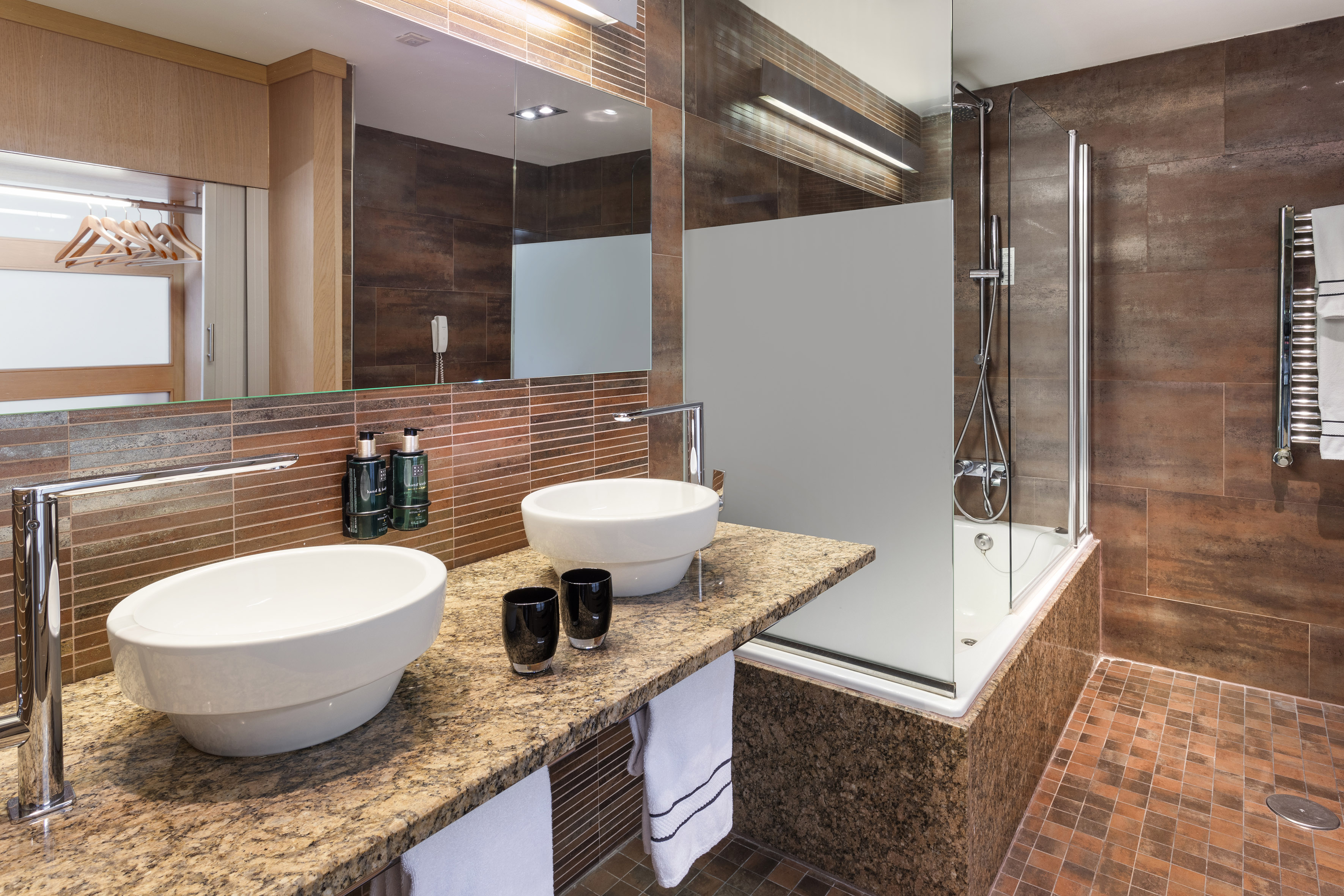 a bathroom with a shower and two sinks