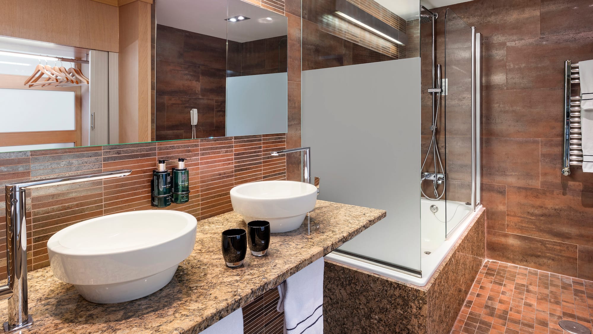 a bathroom with a shower and two sinks