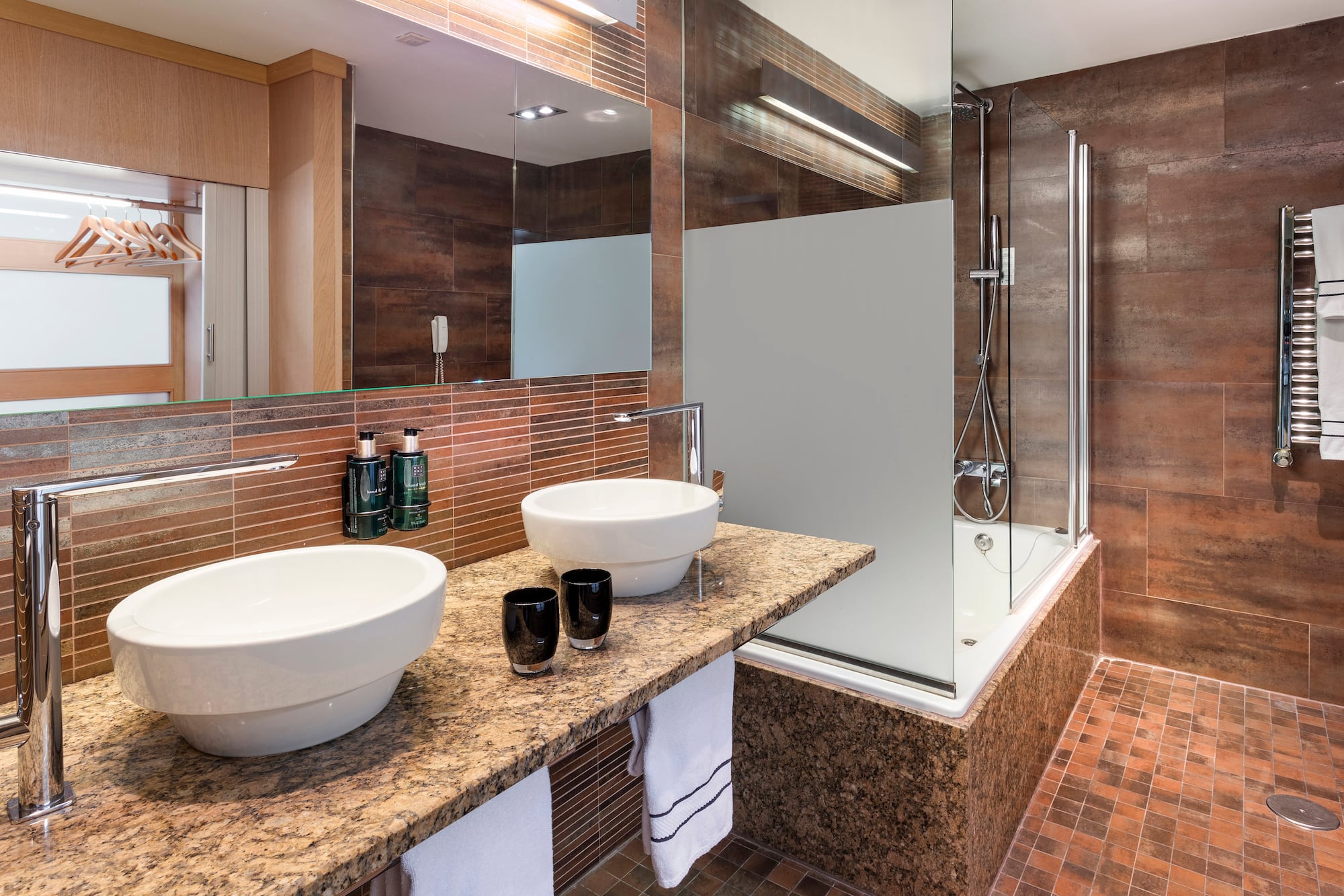 a bathroom with a shower and two sinks