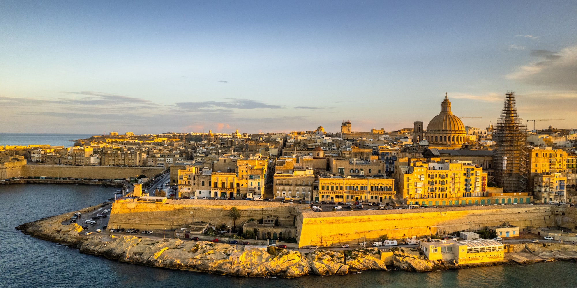 Valletta, Malta, fortified city along the Mediterranean Sea at sunset.