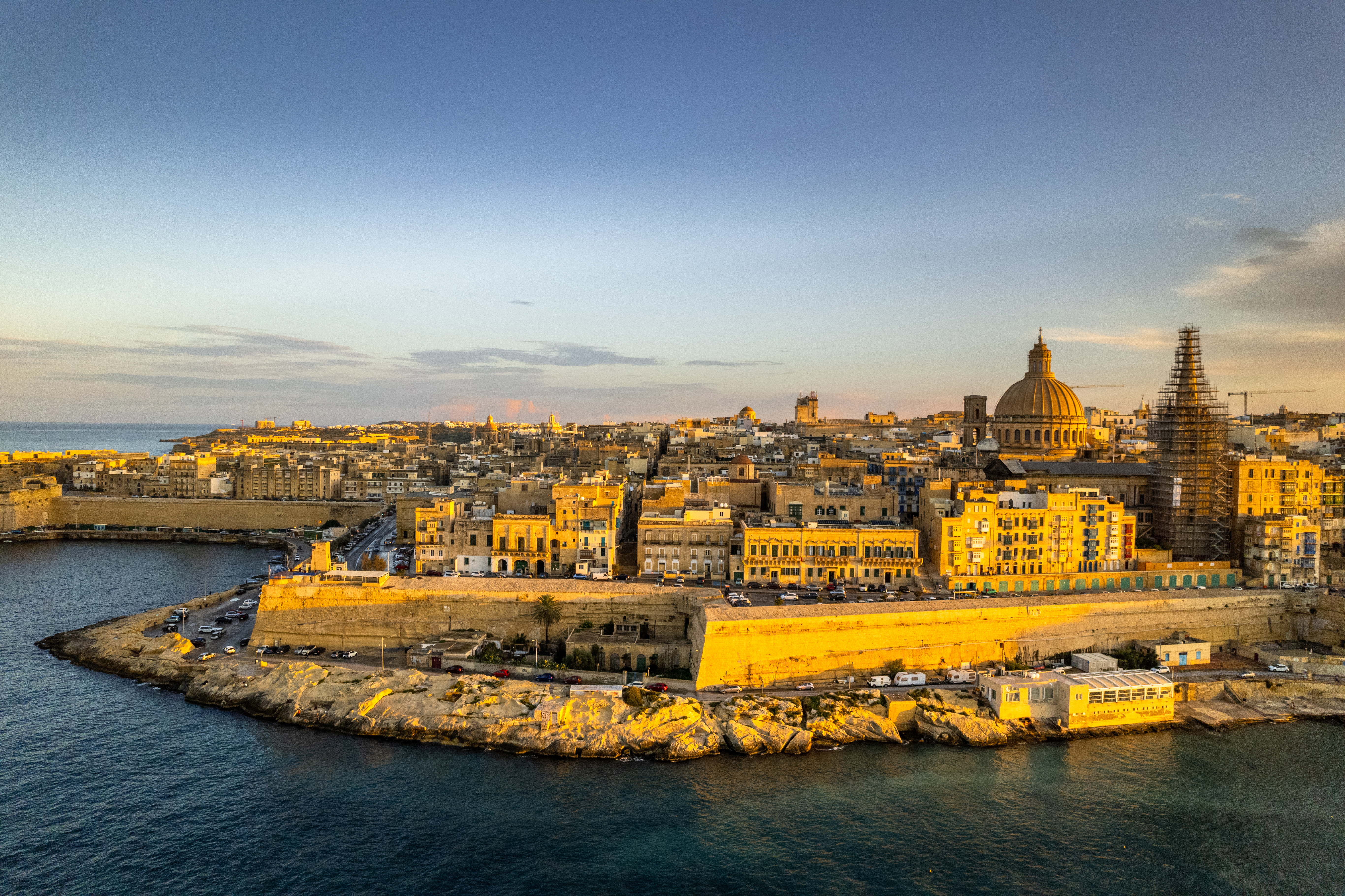 Valletta, Malta, fortified city along the Mediterranean Sea at sunset.