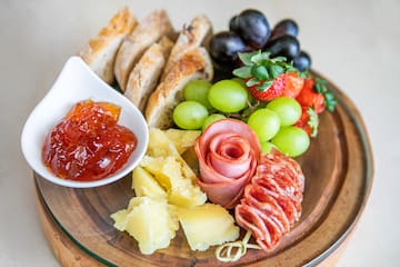 a plate of food with fruit and jam