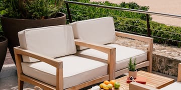 a chair and table on a patio overlooking a beach