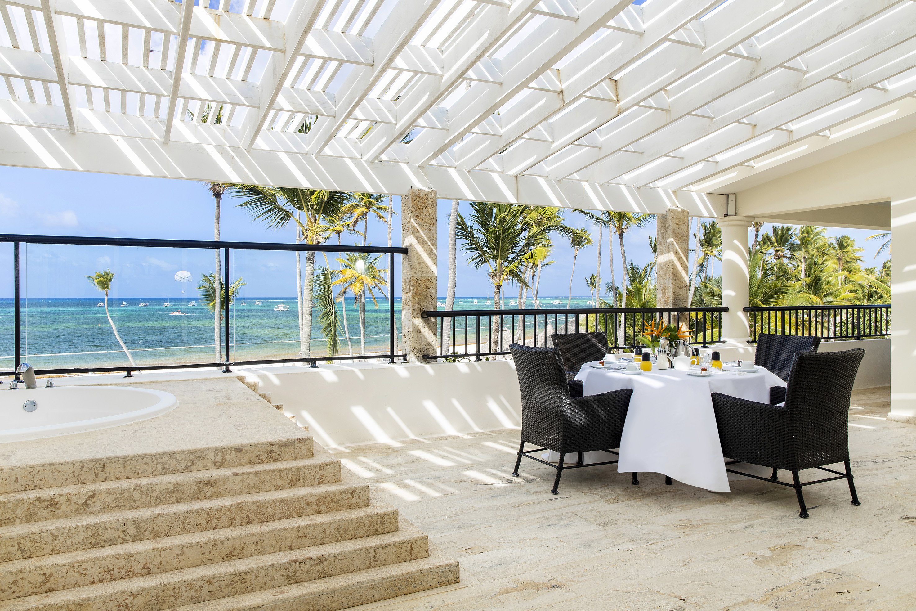 a table set up on a patio with a view of the ocean