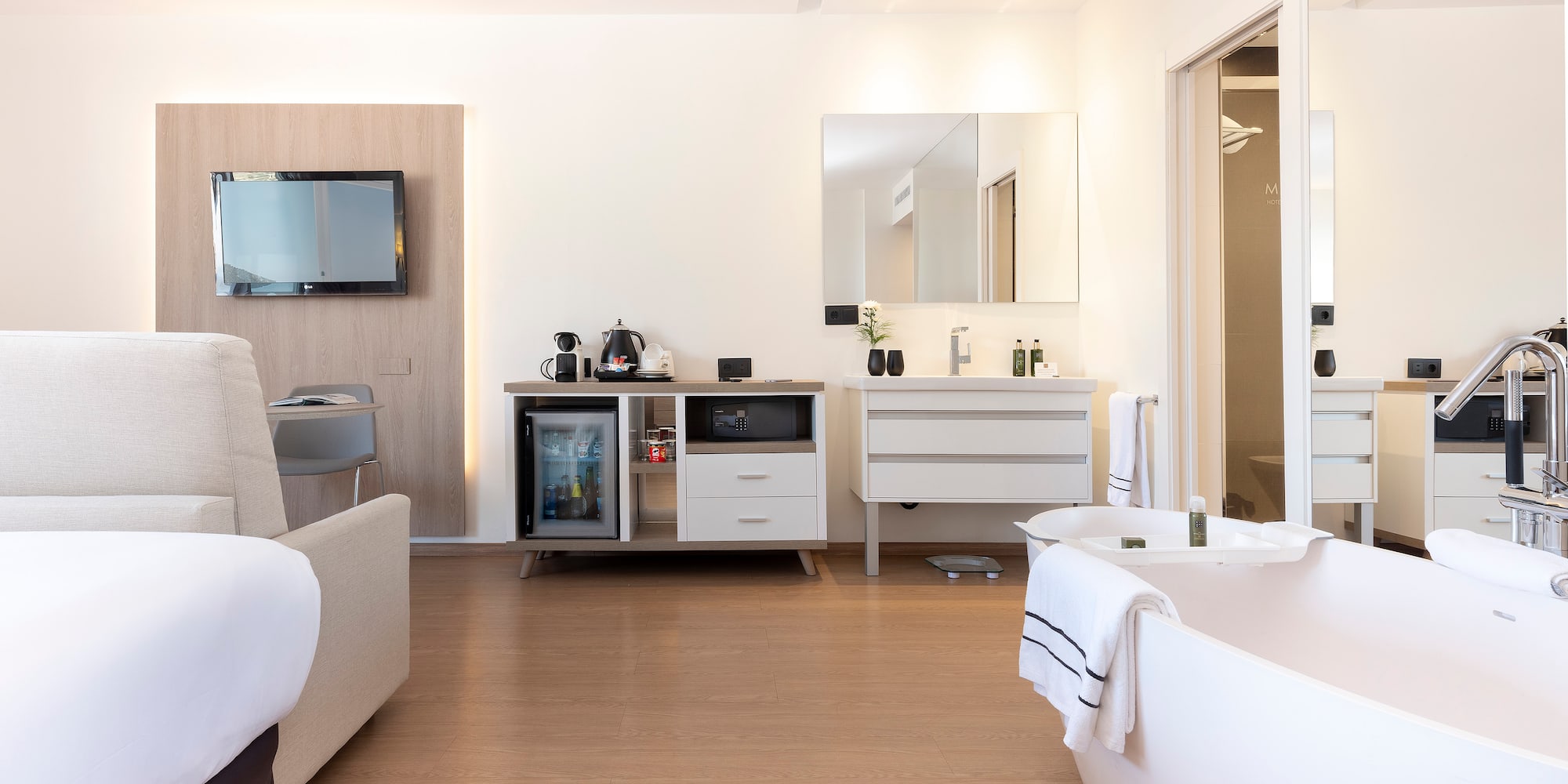 a room with a bathtub and a television