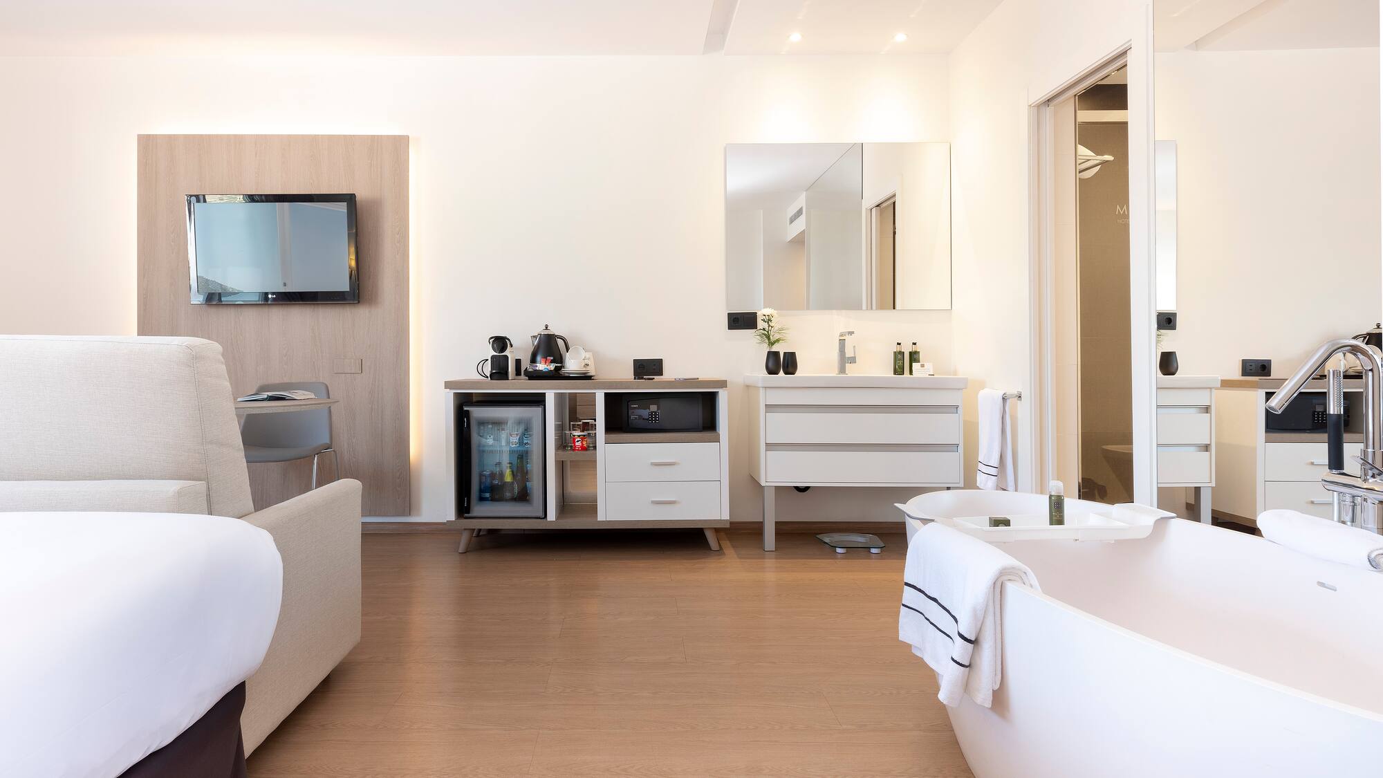 a room with a bathtub and a television