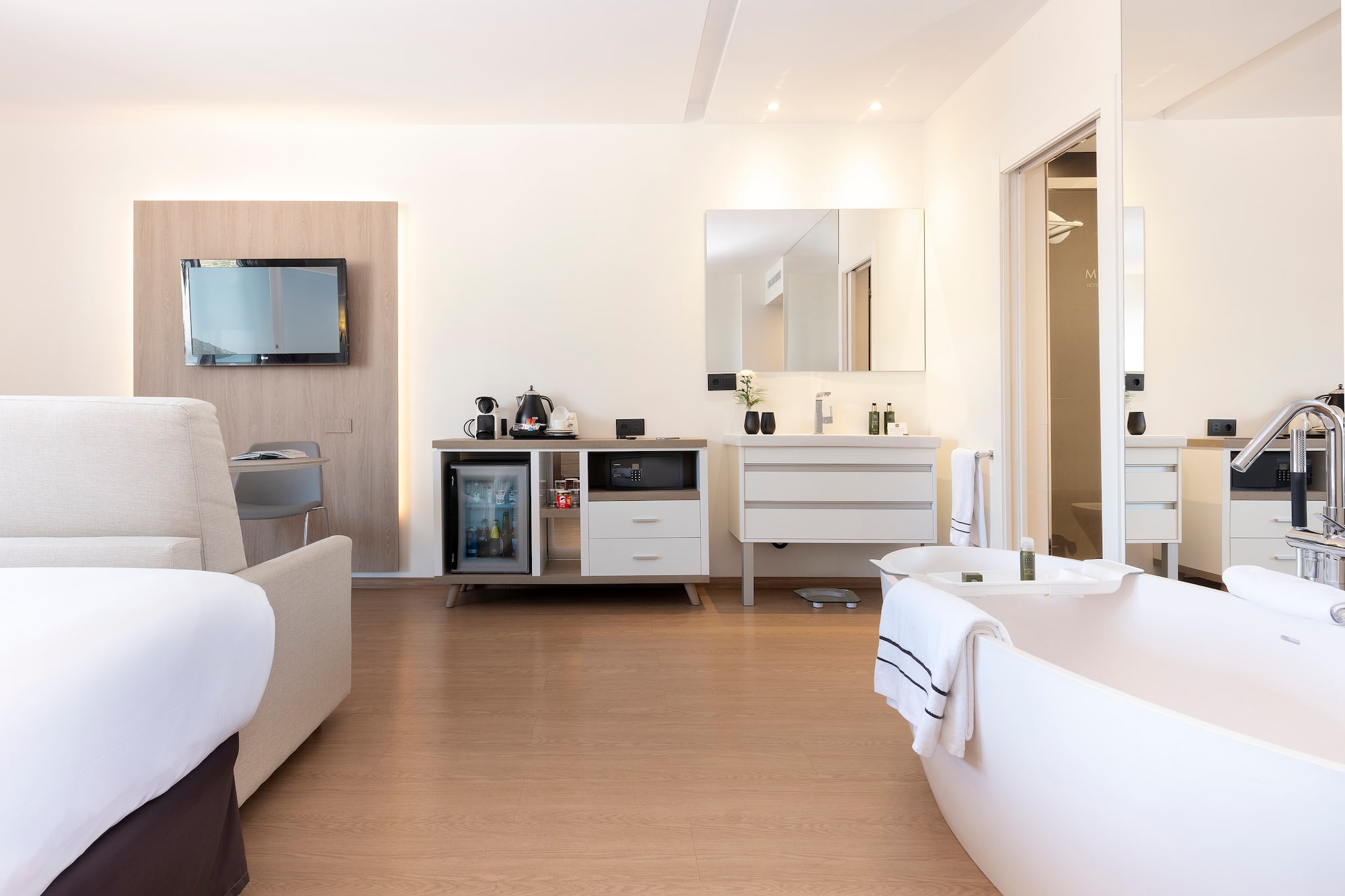 a room with a bathtub and a television