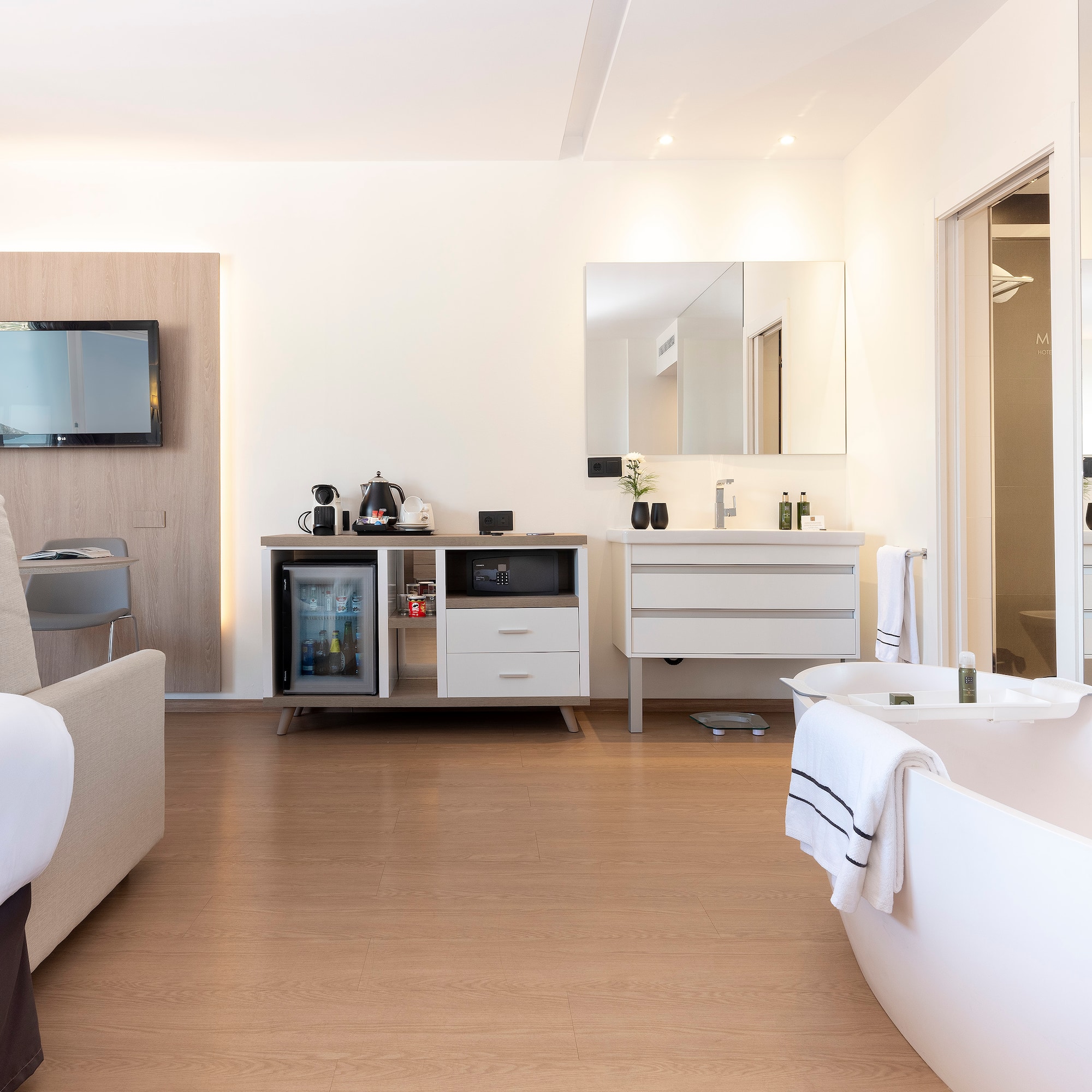 a room with a bathtub and a television