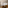 Bright modern hotel bedroom with bed, desk, sofa, and balcony access.