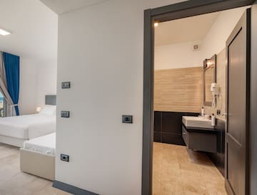 a bedroom with a double bed and sink