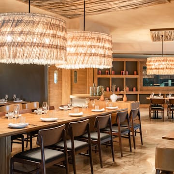 a large dining room with a large table and chairs
