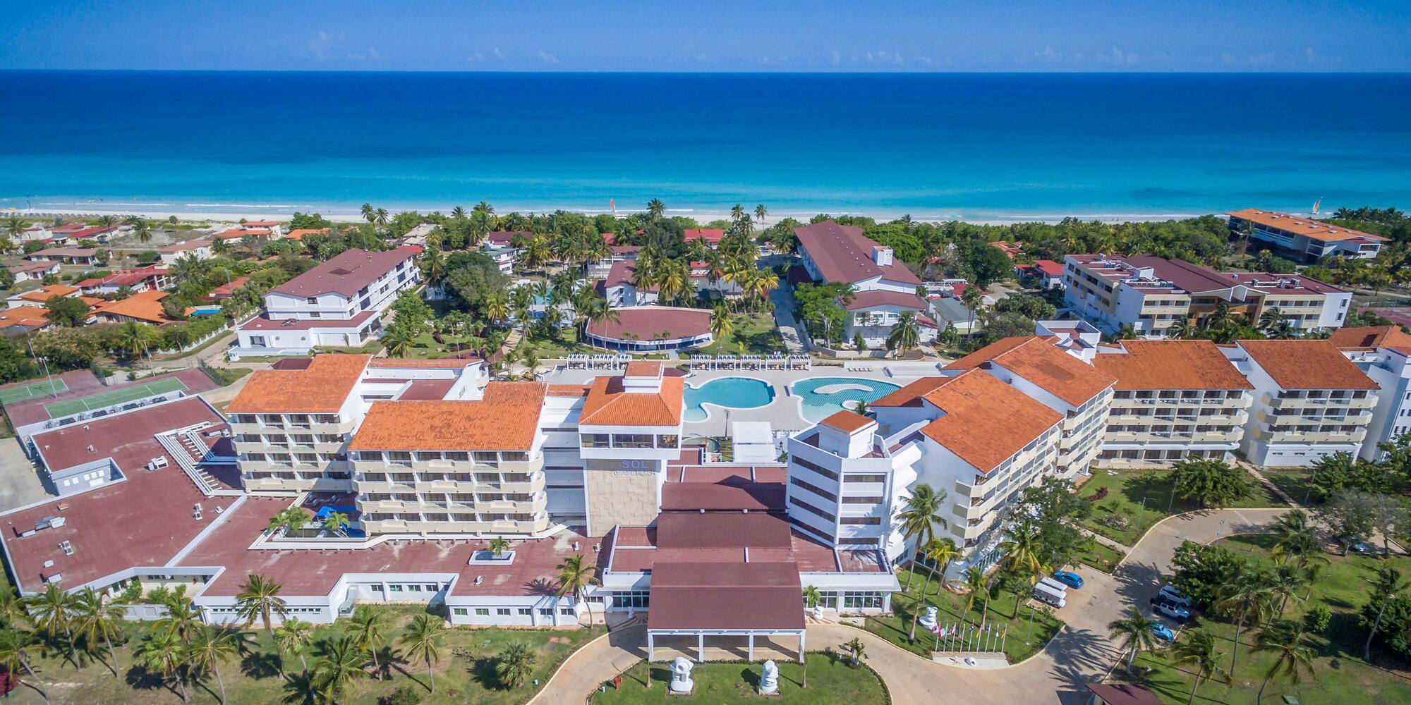 a group of buildings next to a beach