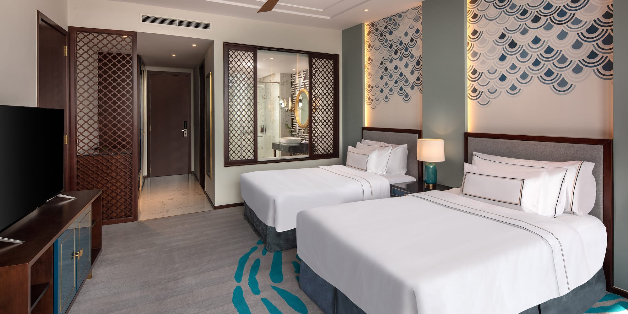 a room with two beds and a fan