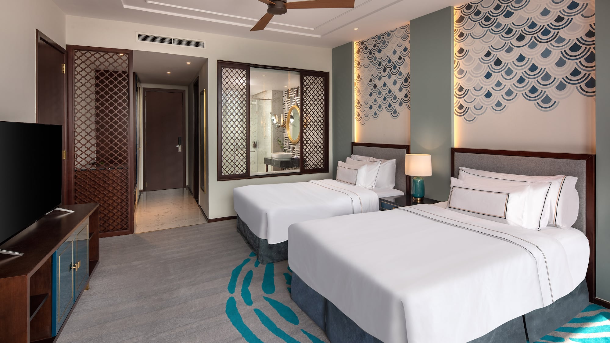 a room with two beds and a fan