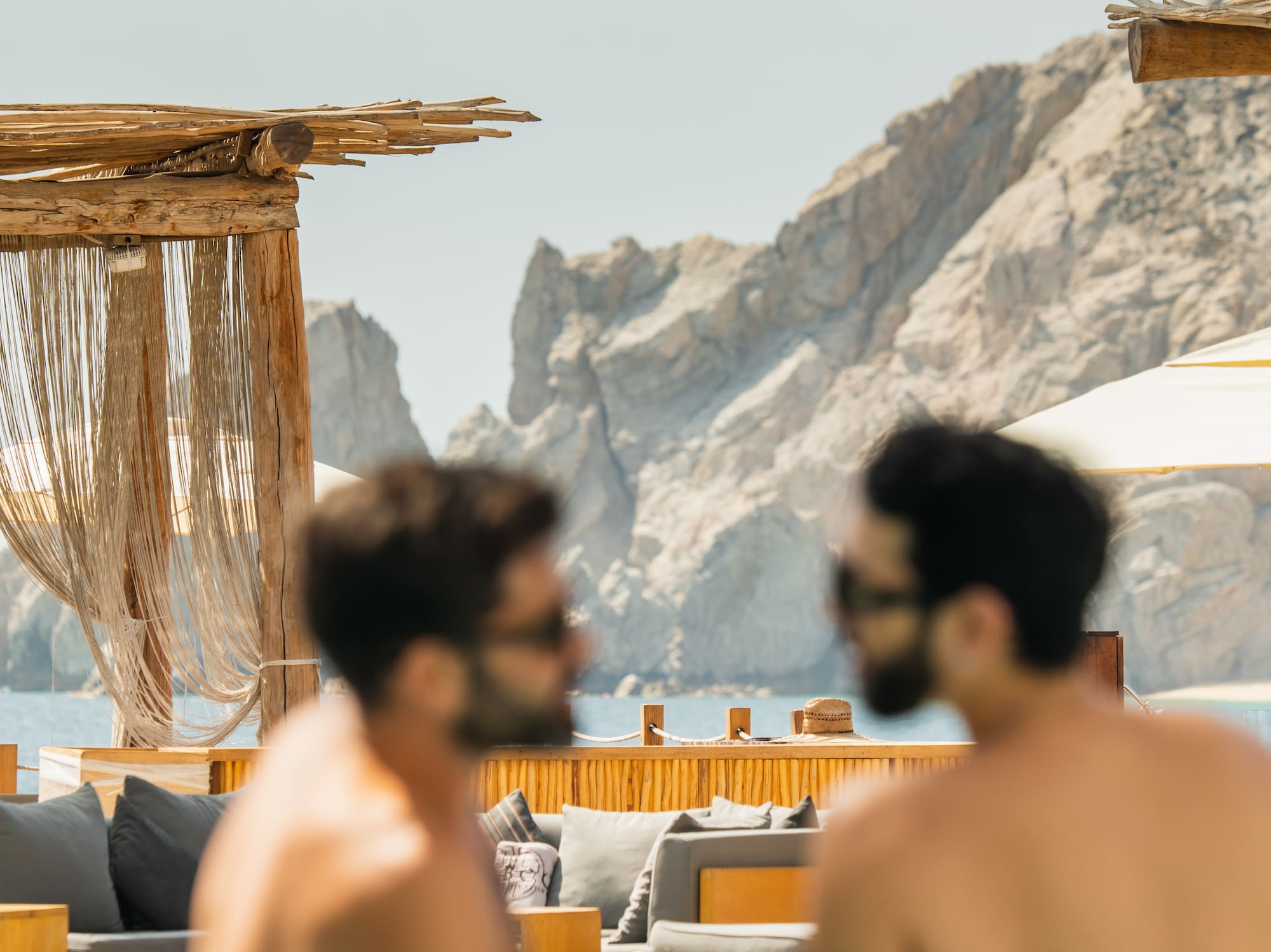 a group of men sitting at a pool