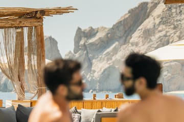 a group of men sitting at a pool