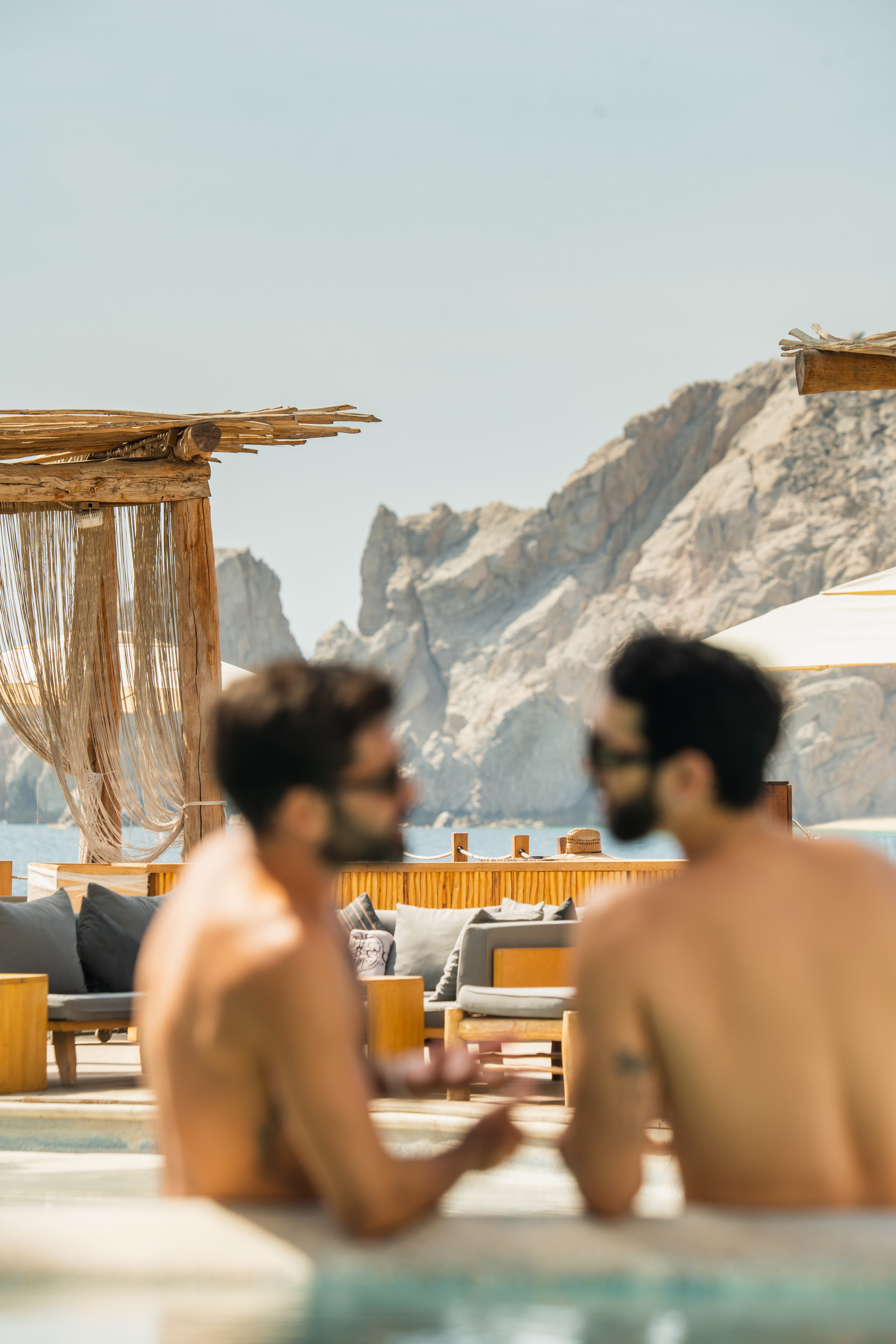 a group of men sitting at a pool