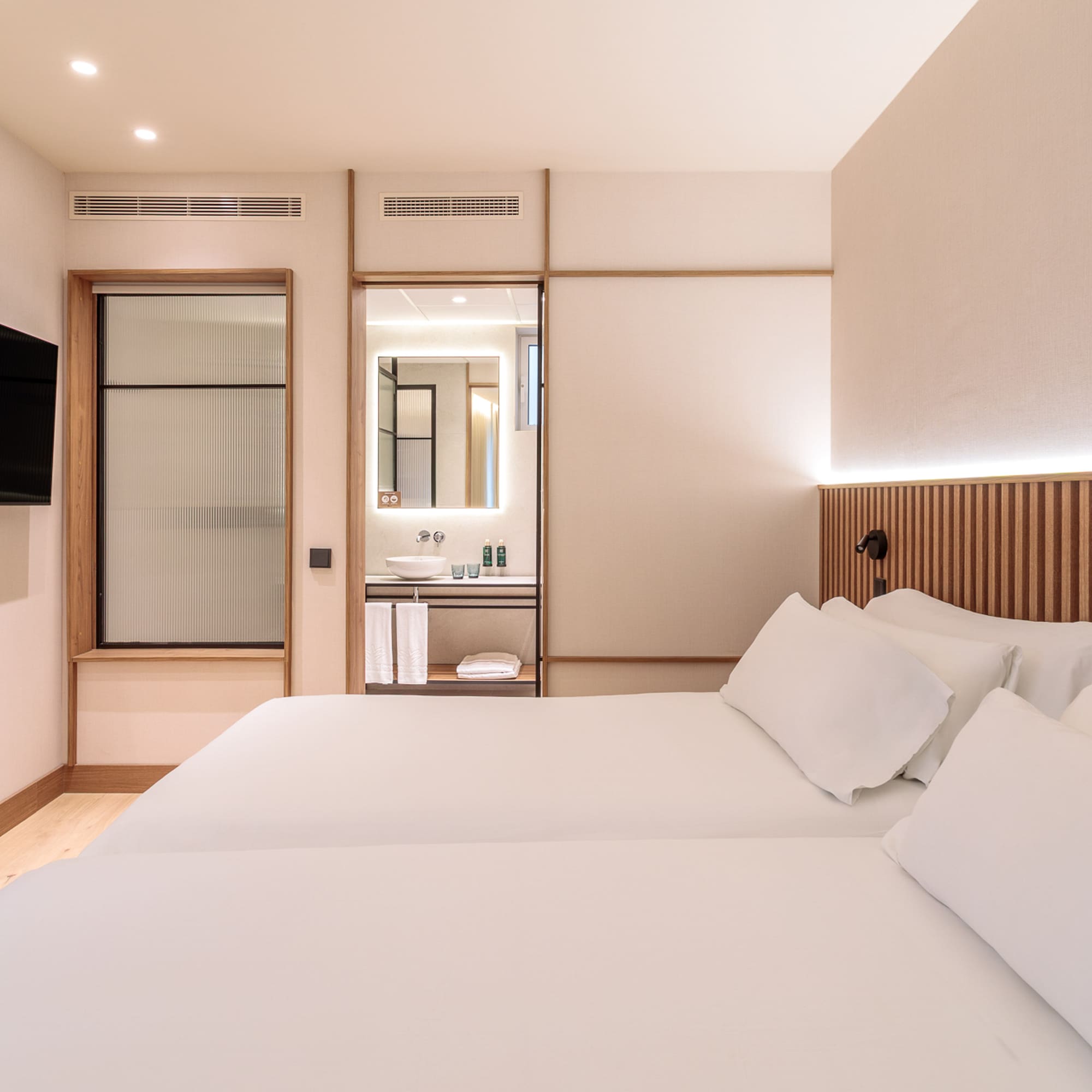 a room with two beds and a television