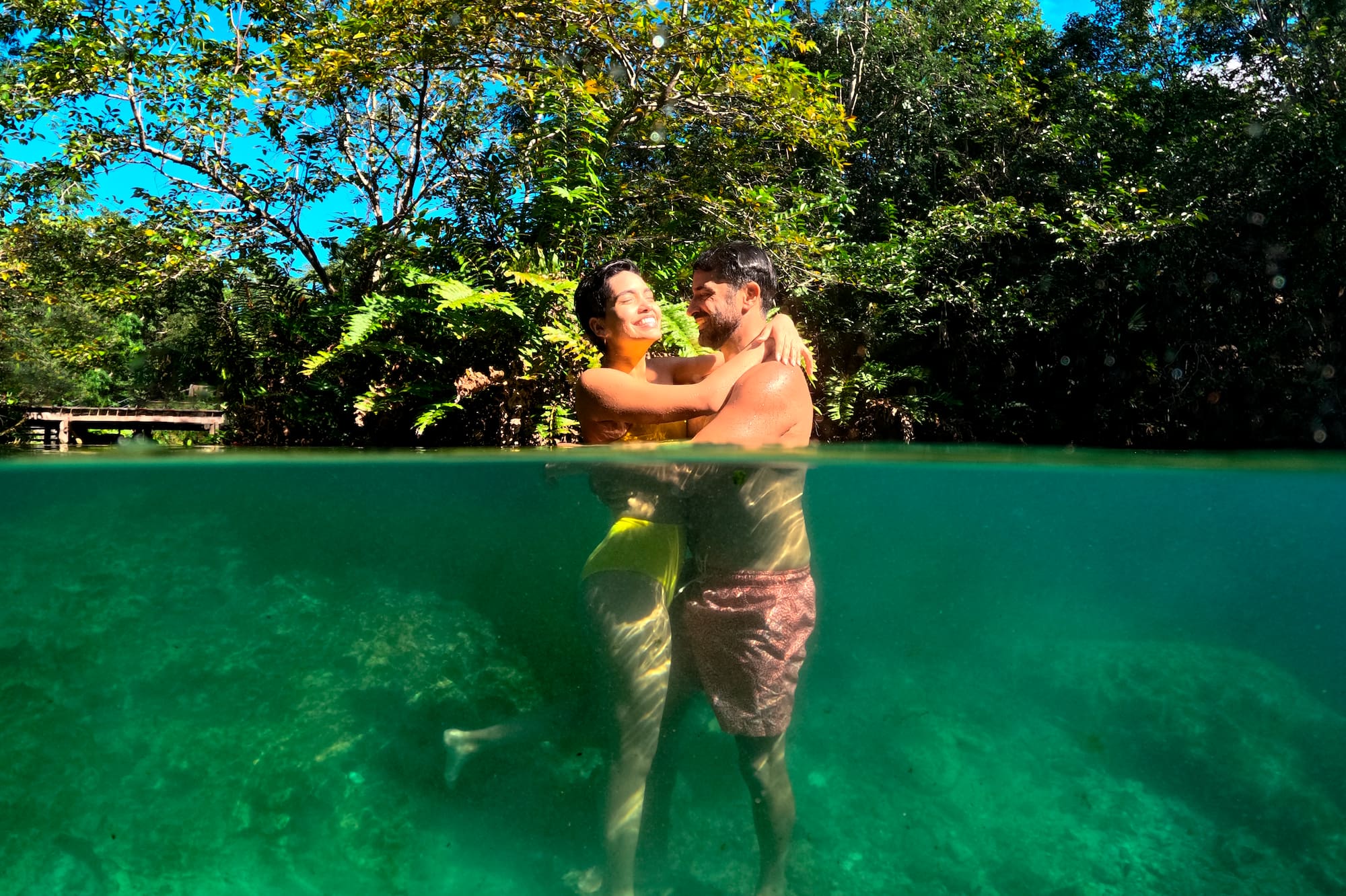 a man and woman hugging in water