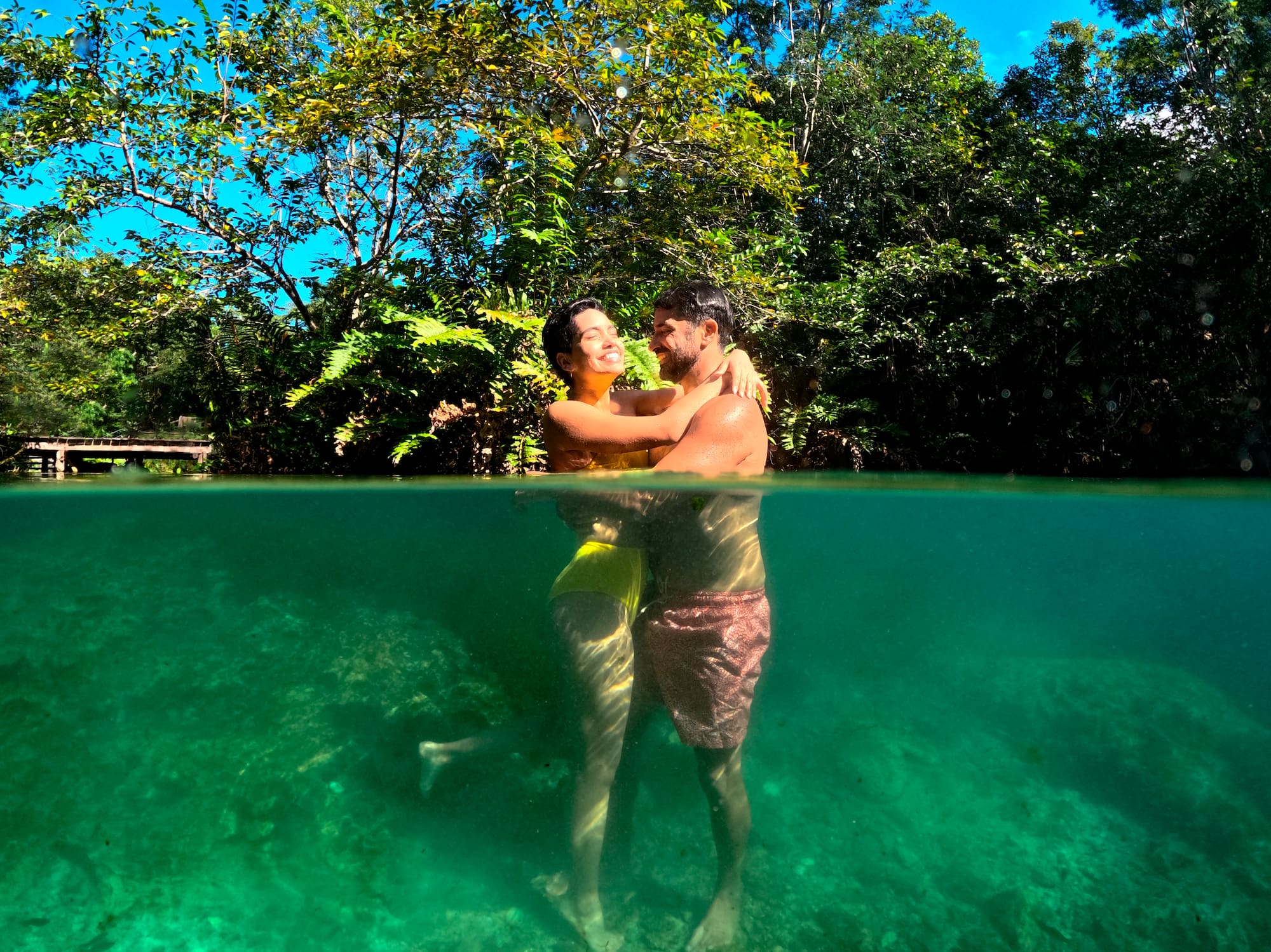 a man and woman hugging in water