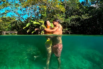 a man and woman hugging in water