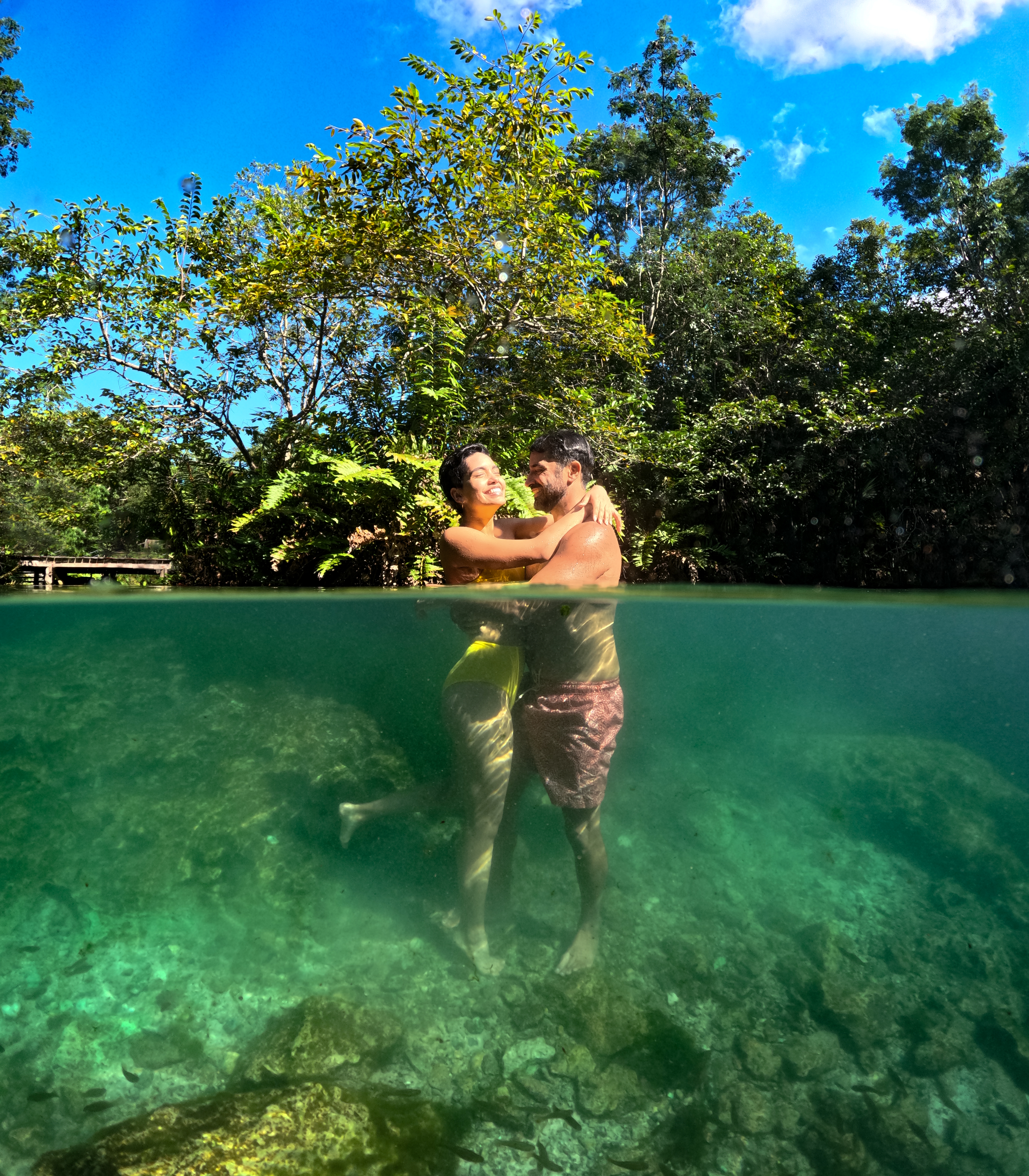 a man and woman hugging in water
