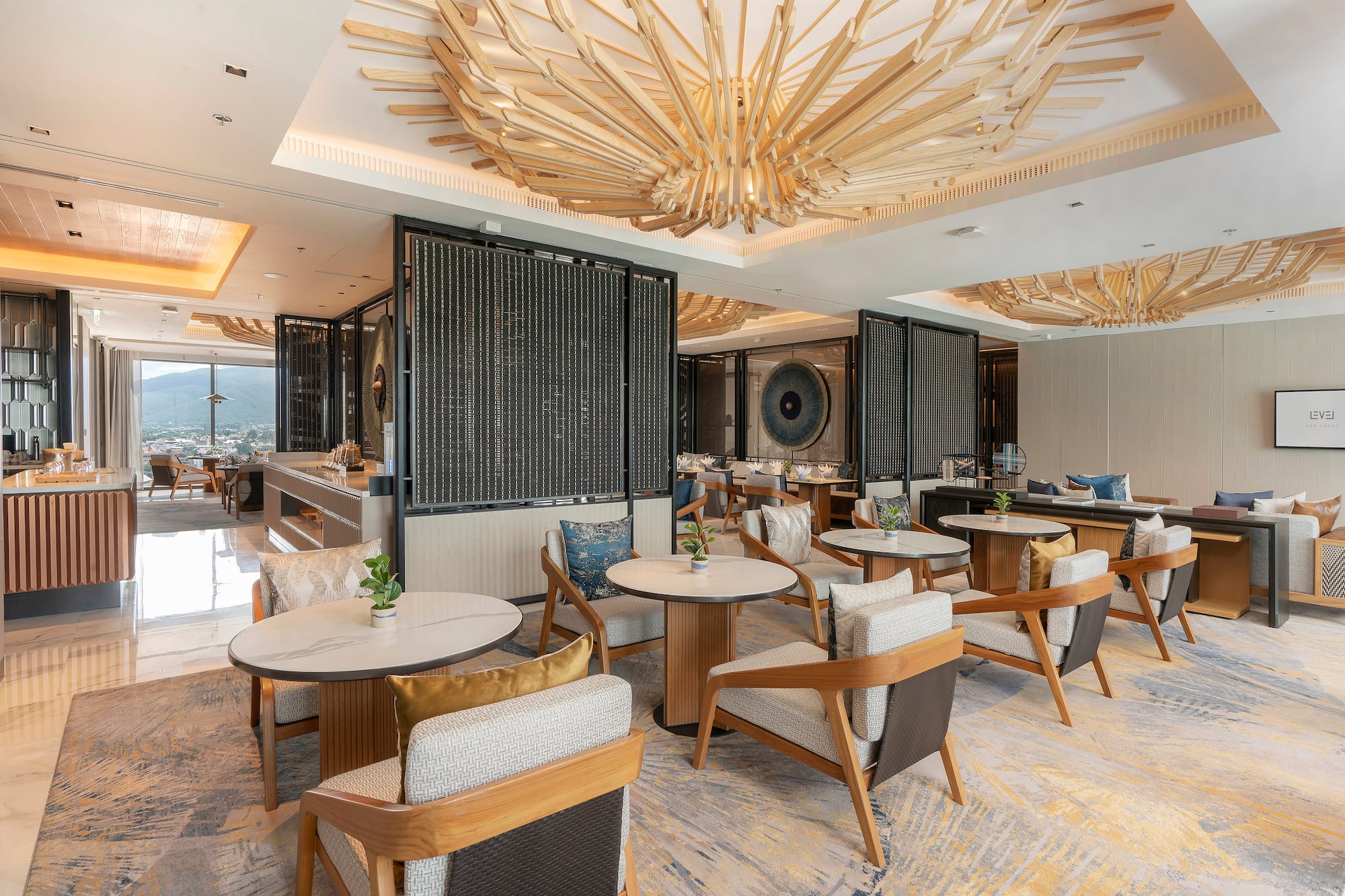 Modern luxury lounge with wooden ceiling, contemporary seating, and city view.