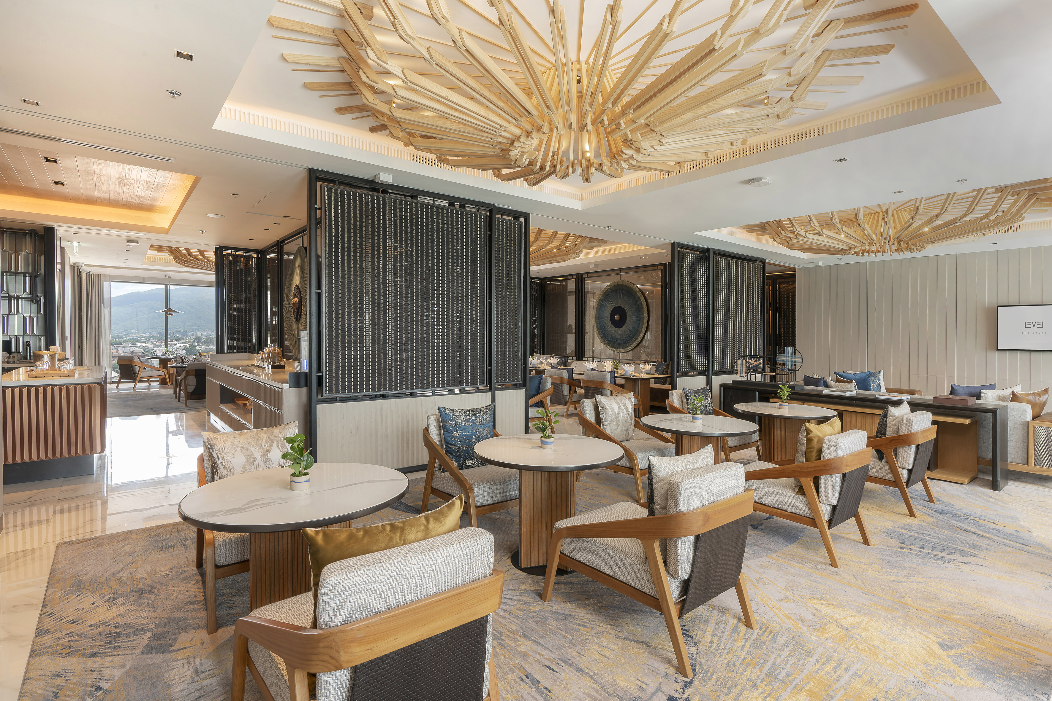 Modern luxury lounge with wooden ceiling, contemporary seating, and city view.