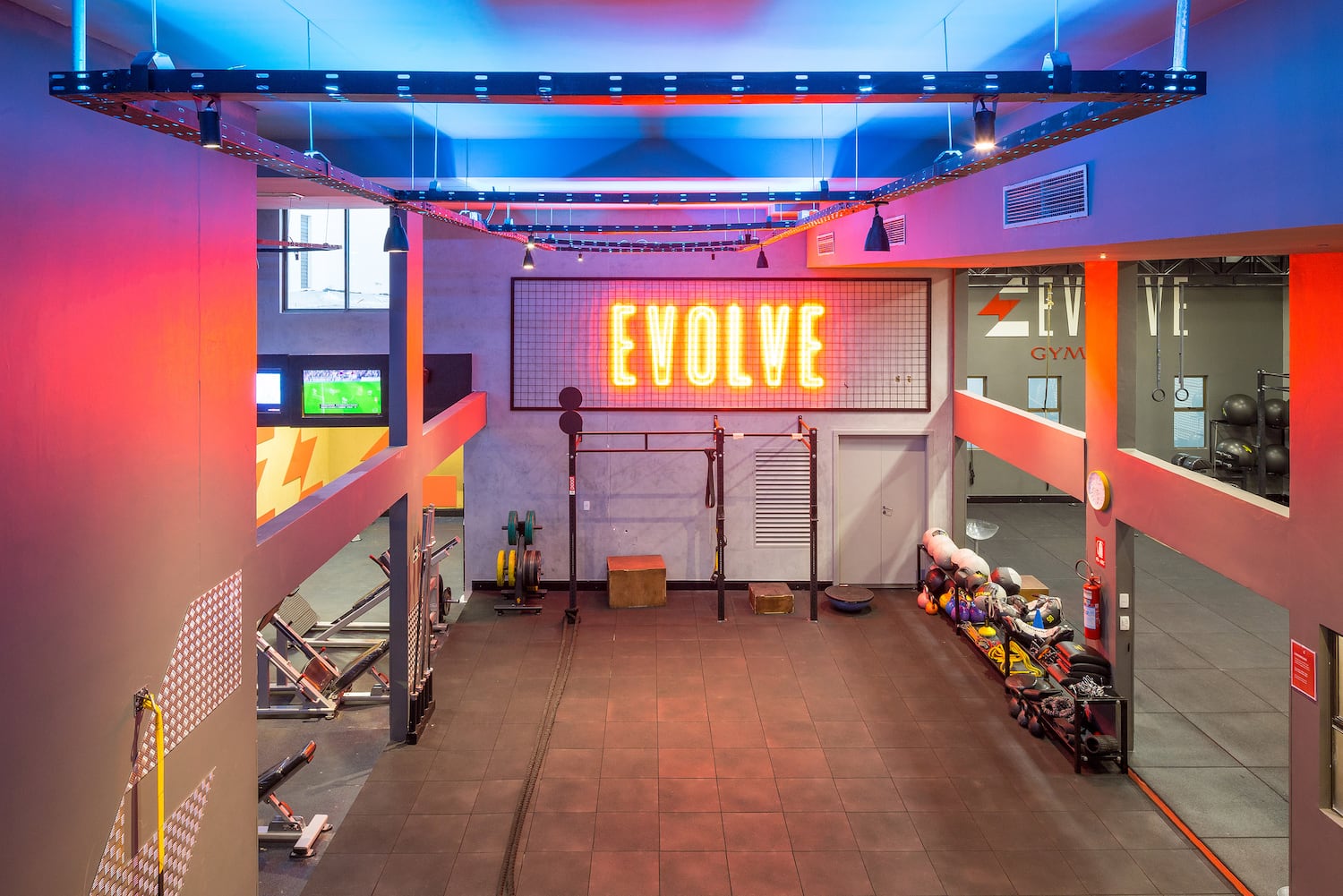 a gym with a neon sign
