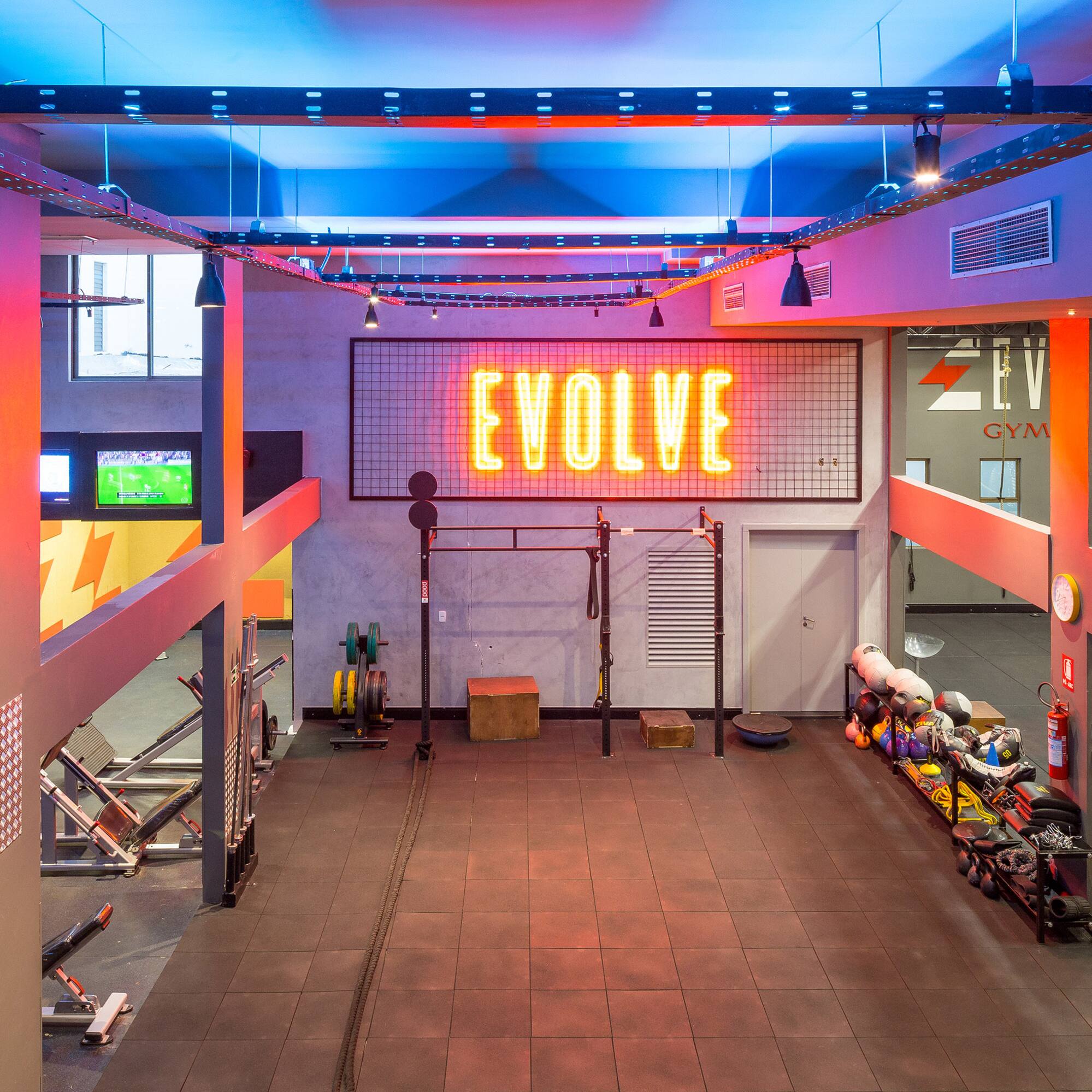 a gym with a neon sign
