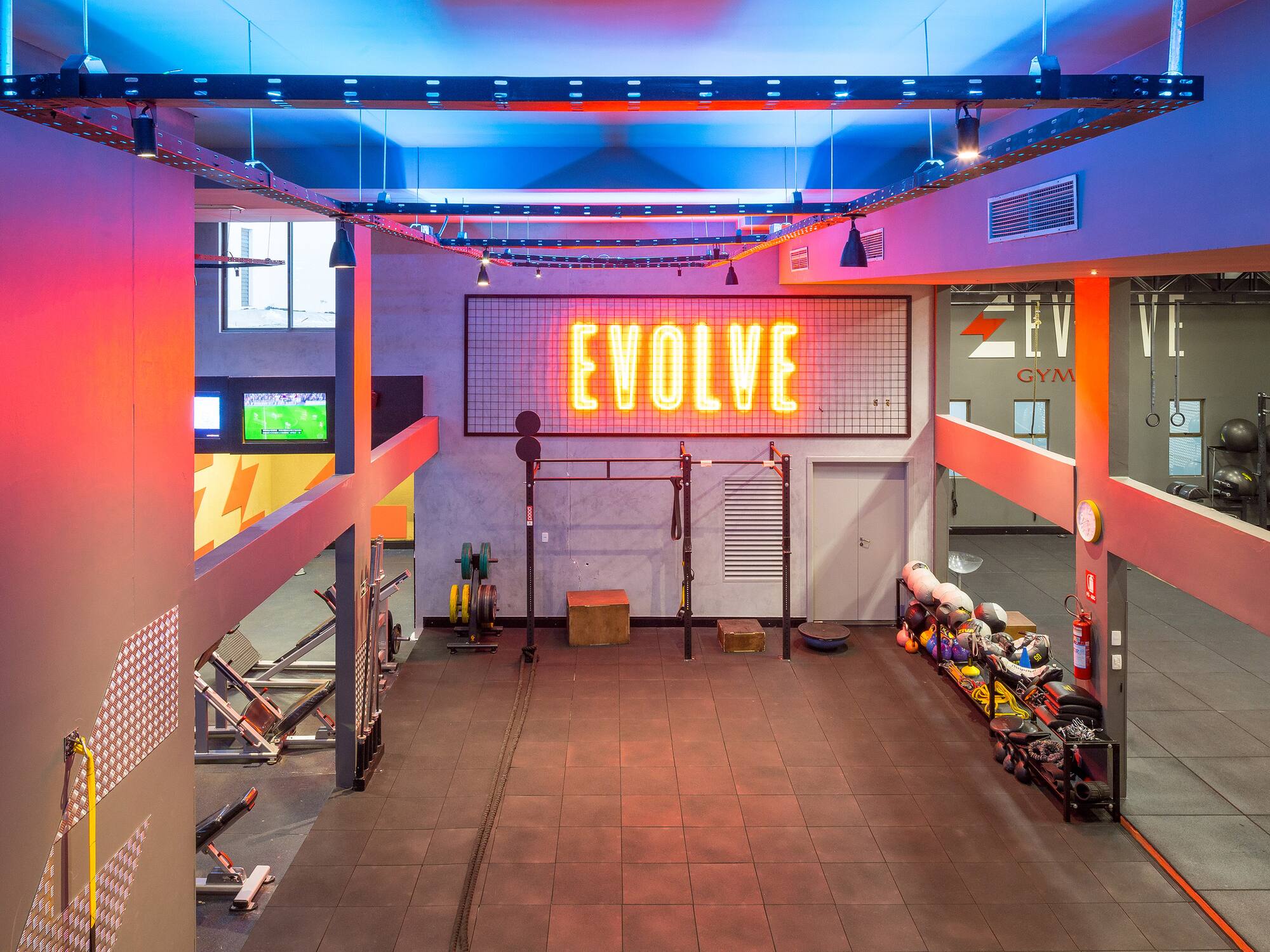 a gym with a neon sign
