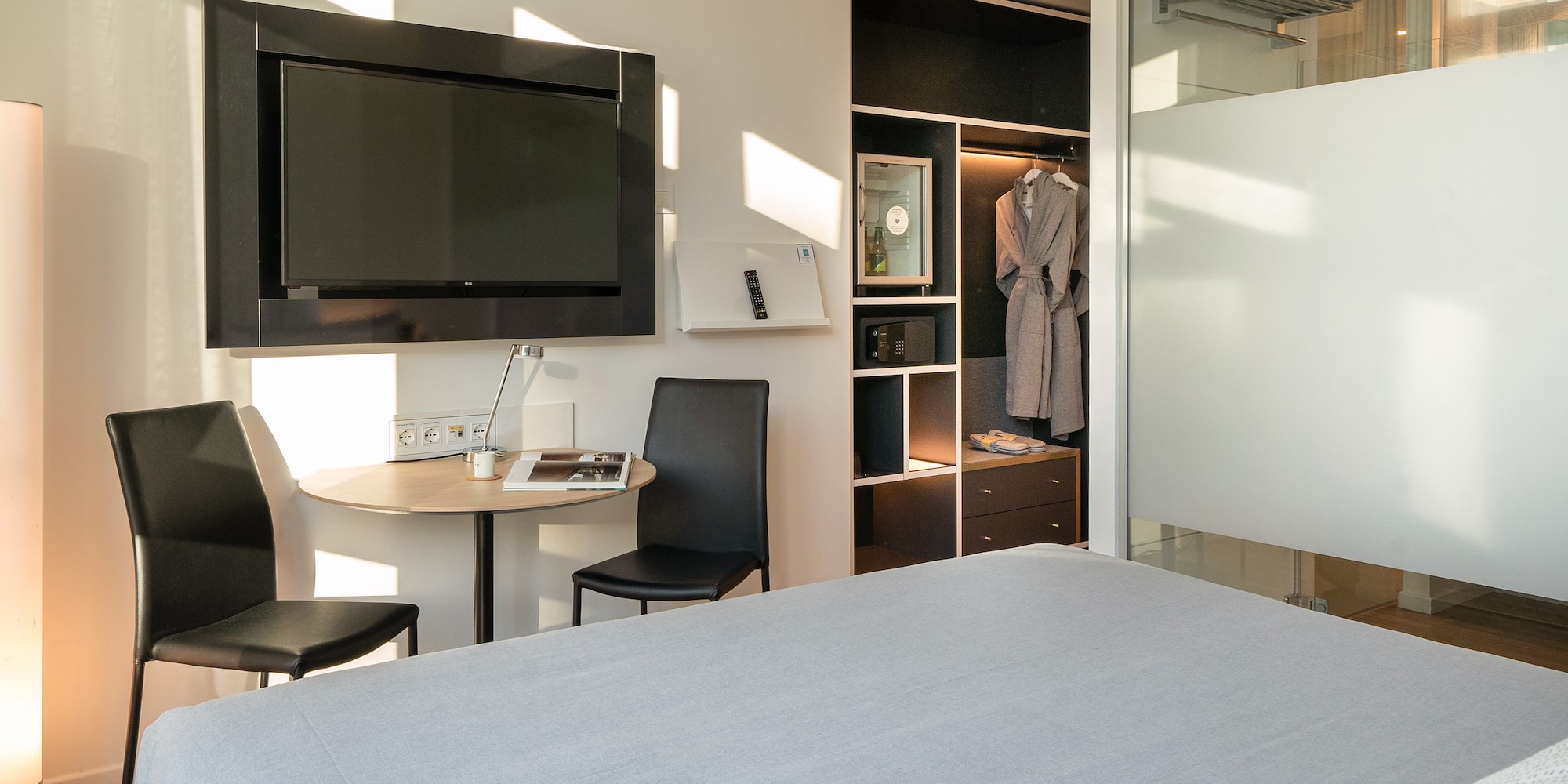 a room with a bed and a table and chair