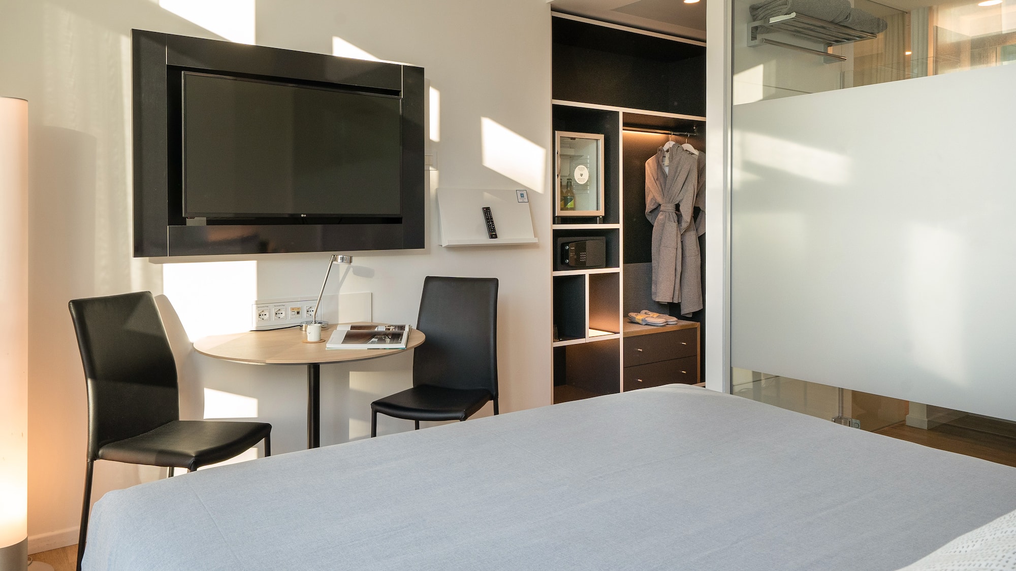 a room with a bed and a table and chair