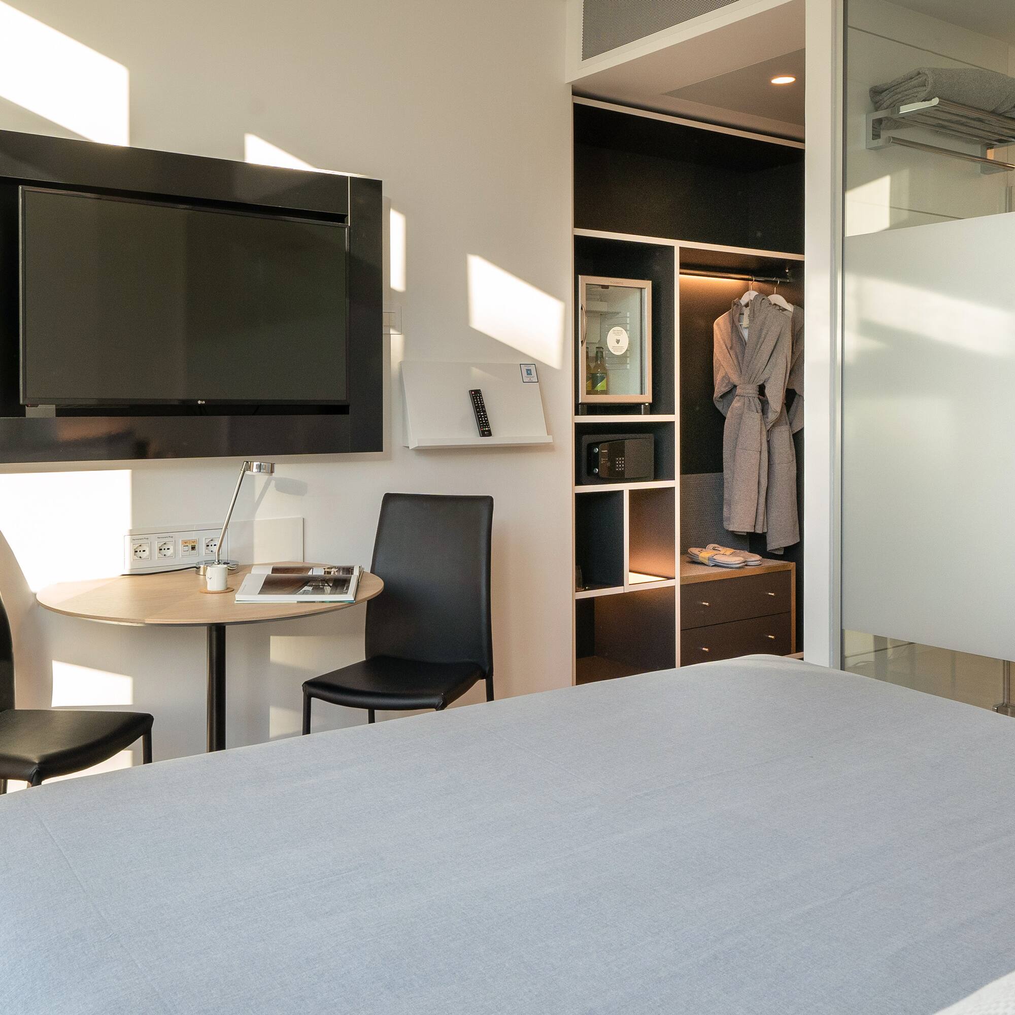 a room with a bed and a table and chair