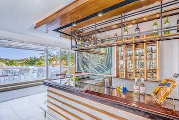 a bar with bottles of liquor on the counter