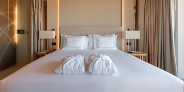 a bed with white towels on it