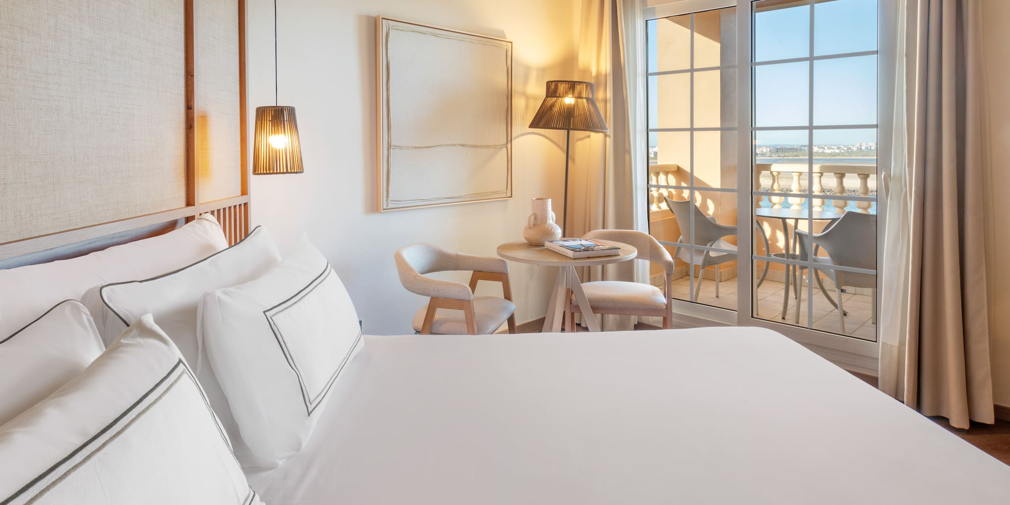 a room with a bed and a table and chairs