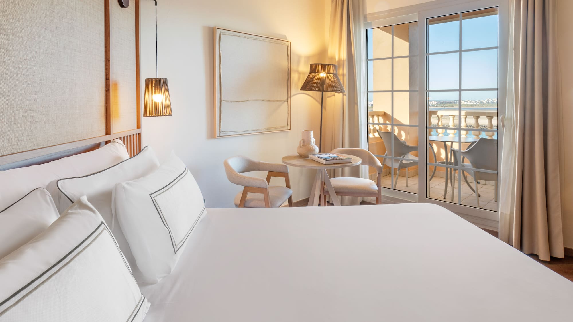 a room with a bed and a table and chairs