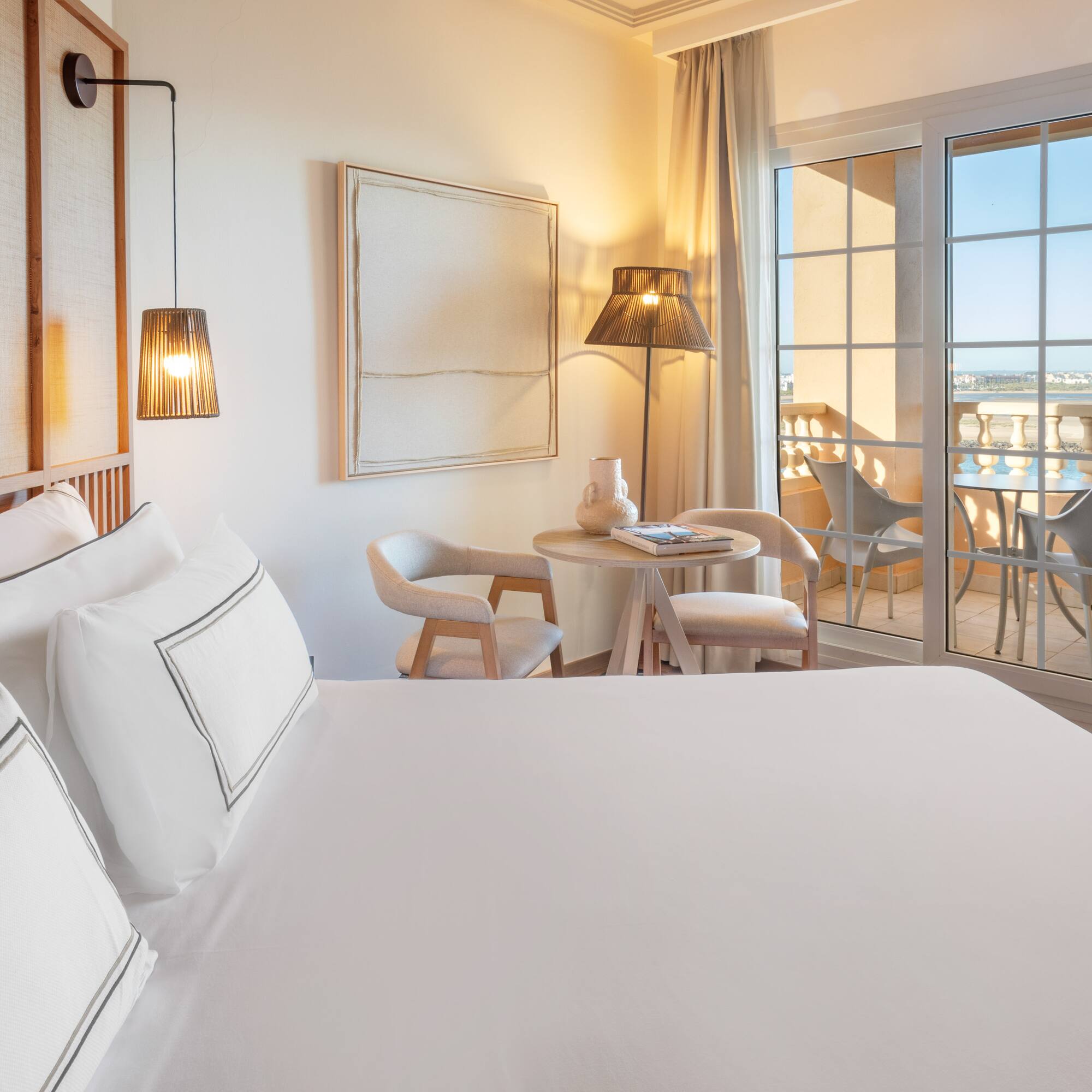 a room with a bed and a table and chairs