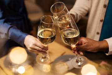 a group of people clinking wine glasses