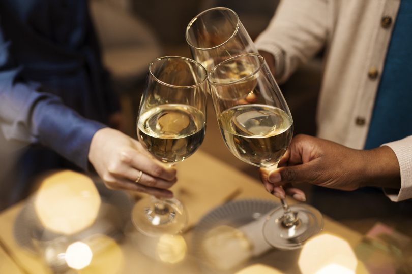 a group of people clinking wine glasses