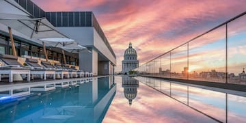 a pool with a building and a city skyline
