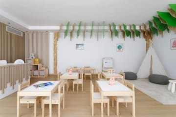 a room with white tables and chairs