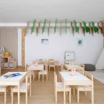 a room with white tables and chairs