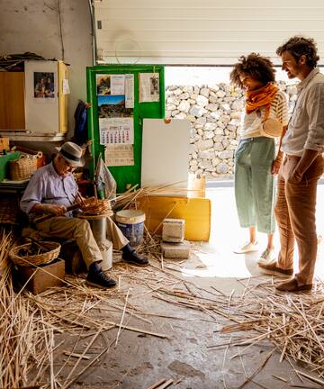 a group of people in a room with straw