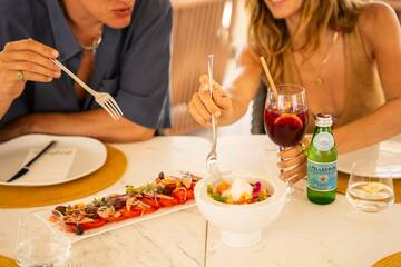 a man and woman eating at a table