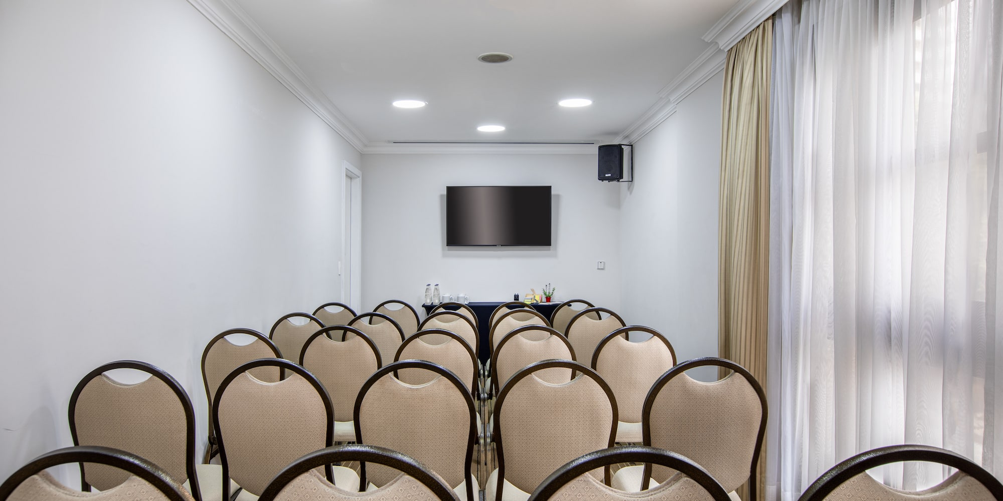 a room with chairs and a television